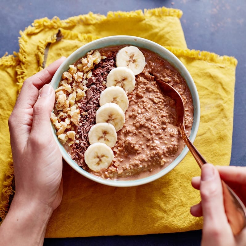 Exante hot choco-oats porridge topped with nuts, chocolate and banana