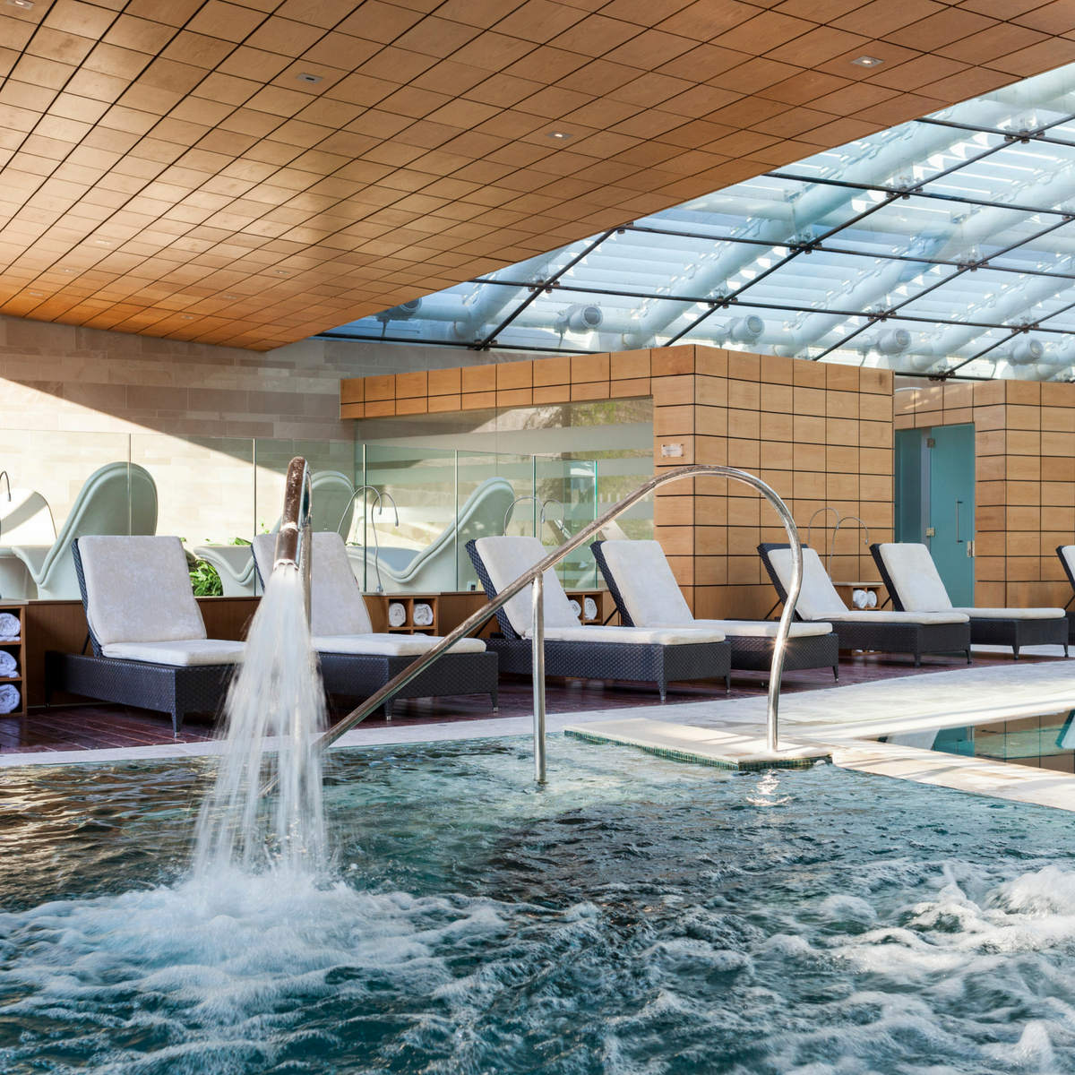 Indoor spa pool with jets and beds to lie on