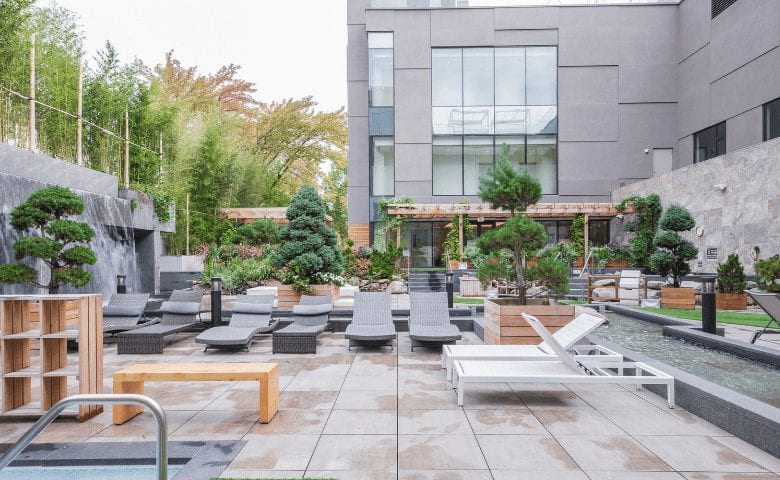 Outdoor terrace with greenery and sun loungers