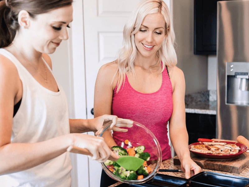 Trainer Kami and friend prepping a healthy healthy and delicious meal