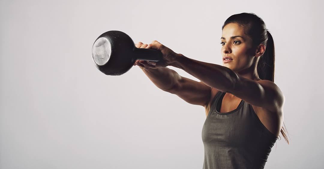 Woman exercise with kettle bell - Crossfit workout
