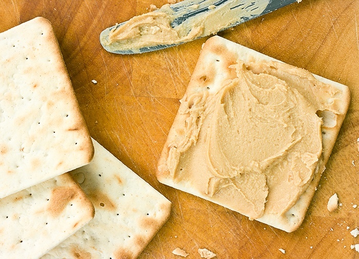 Peanut butter spread on crackers.