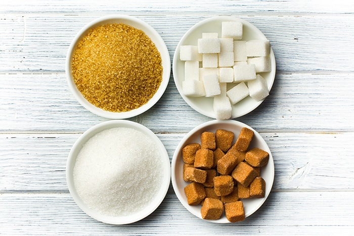 various types of sugar in ceramic bowls
