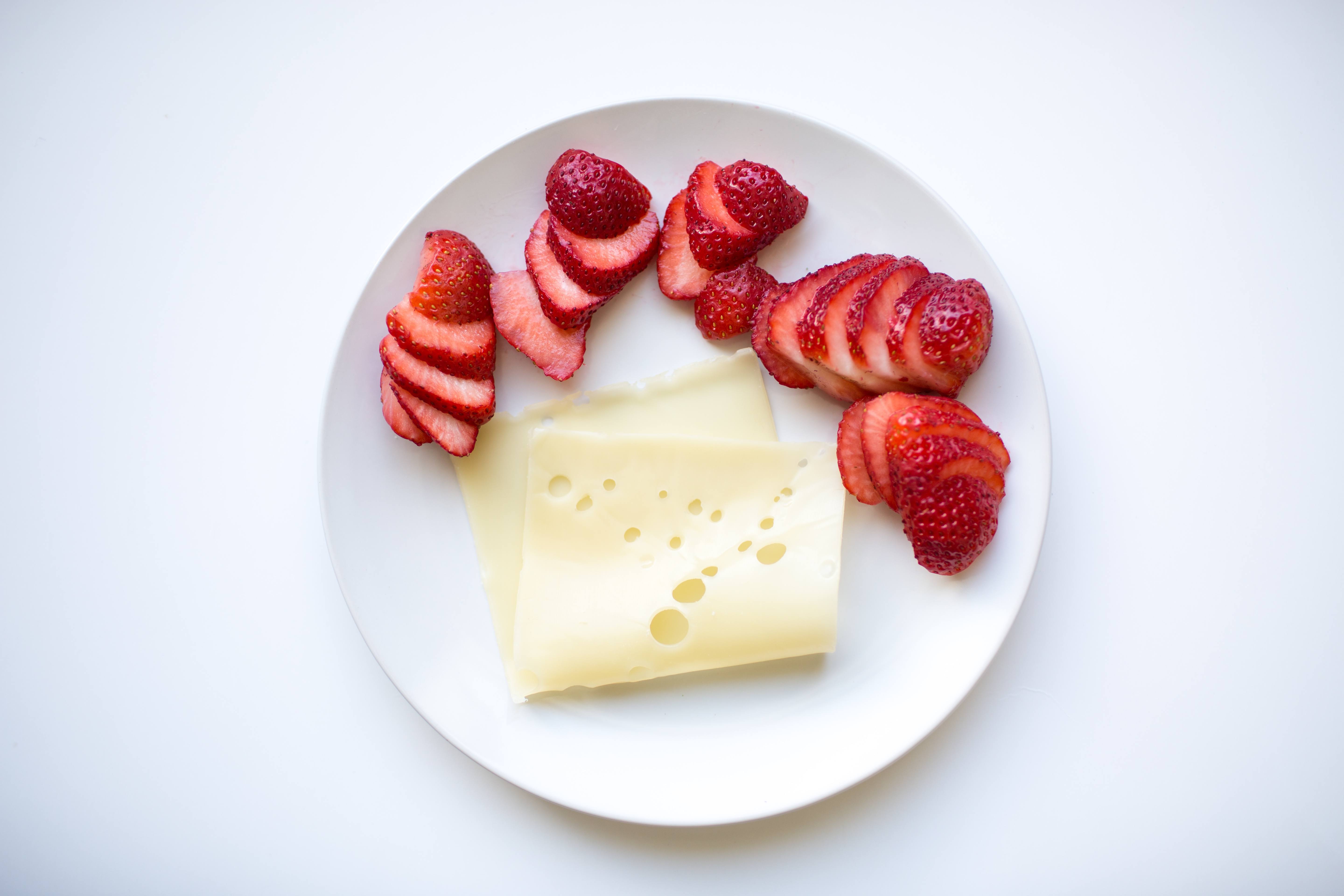 a low calorie snack of swiss cheese and strawberries