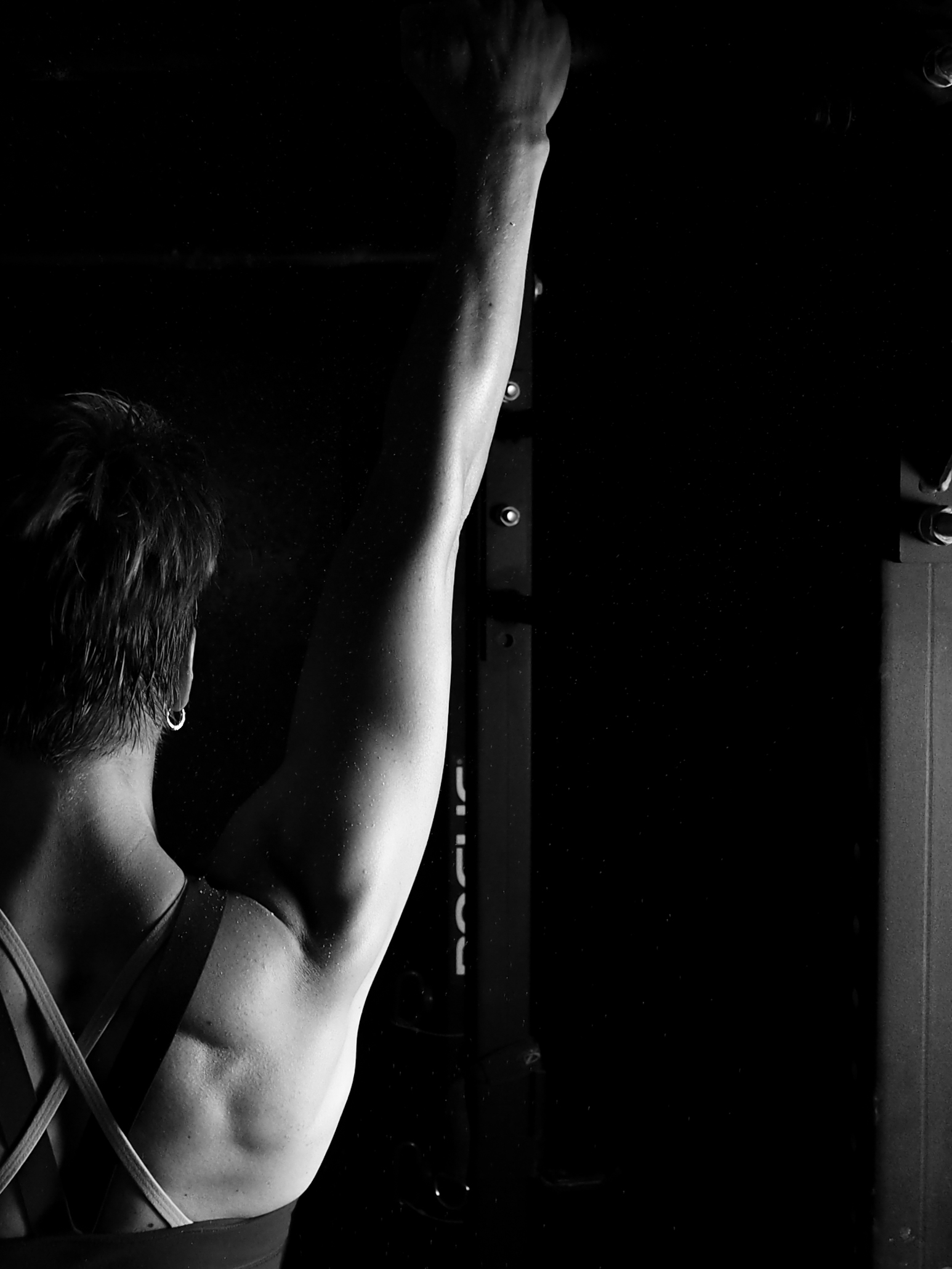 muscular and athletic woman doing pullup