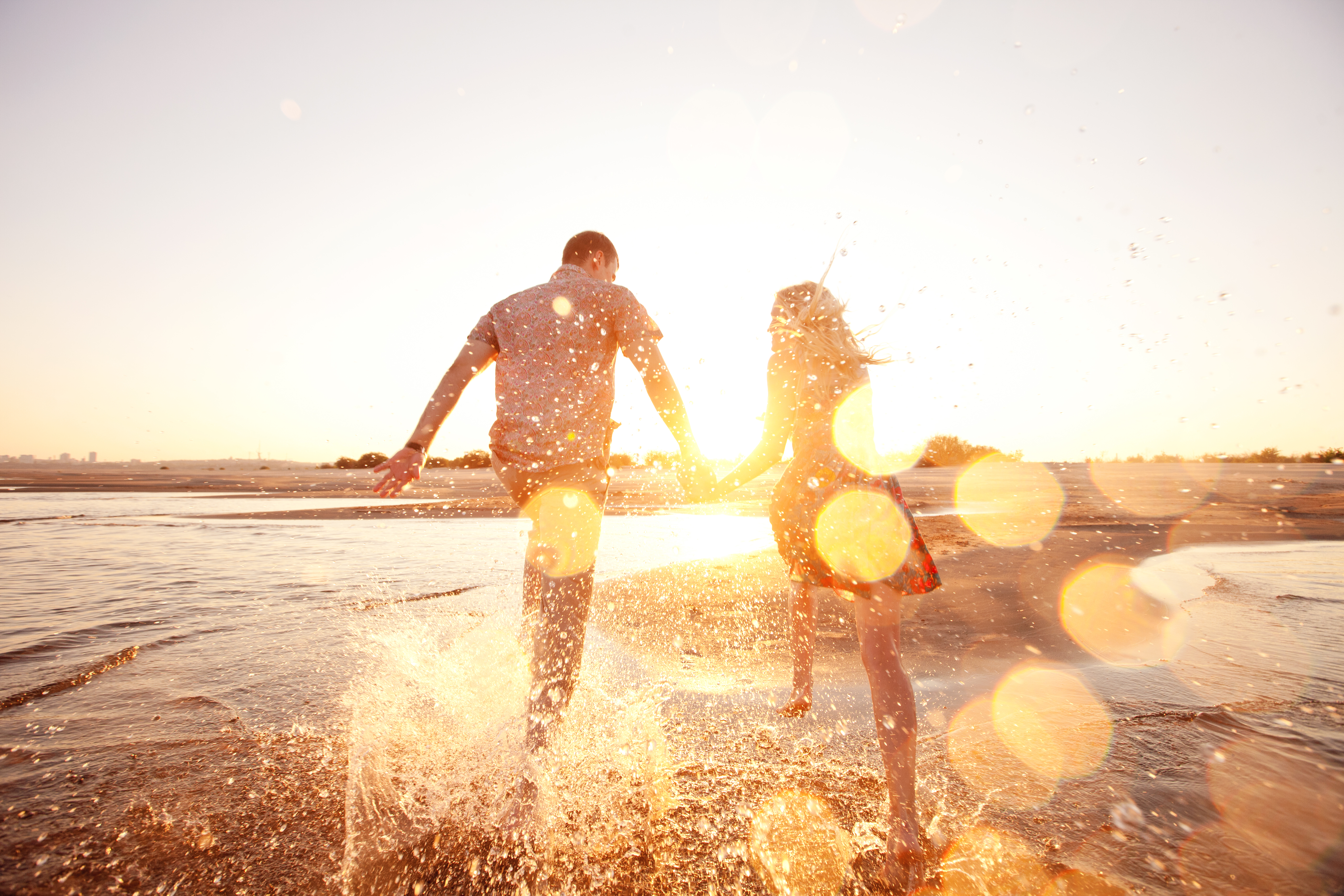 happy couple running on the beach