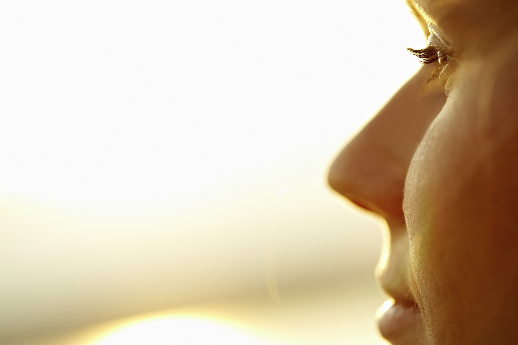 benefits of vitamin d Close-up of profile of young woman looking at sun