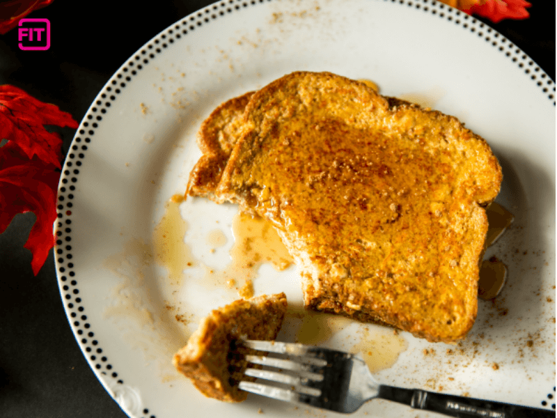 A slice of pumpkin french toast with a bite taken