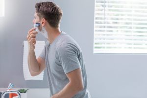 shaving with a Gillette razor and shaving cream