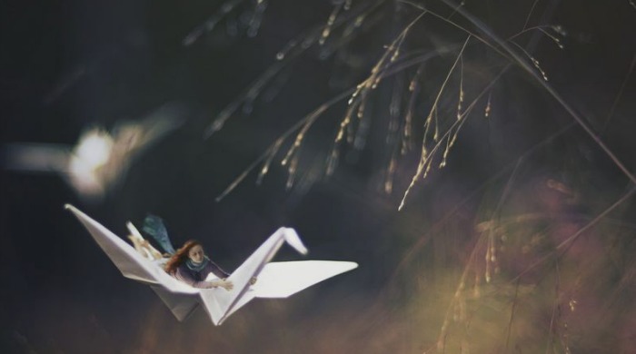 Miniature Landscapes by Fiddleoak: a small girl flying through a field on an origami crane.