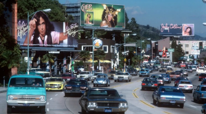 Rock 'n' Roll Billboards of LA's Sunset Strip: Billboards over a busy highway, one of which features Cher.