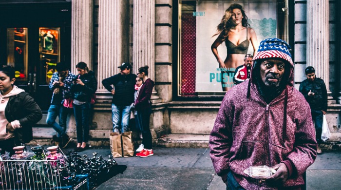 The Streets of New York City by Shaquel Munroe: A view of a group of people on a sidewalk.