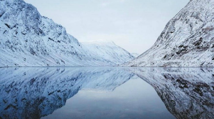 Alex Strohl Fjords of Norway: Snow-covered fjords on a still lake.