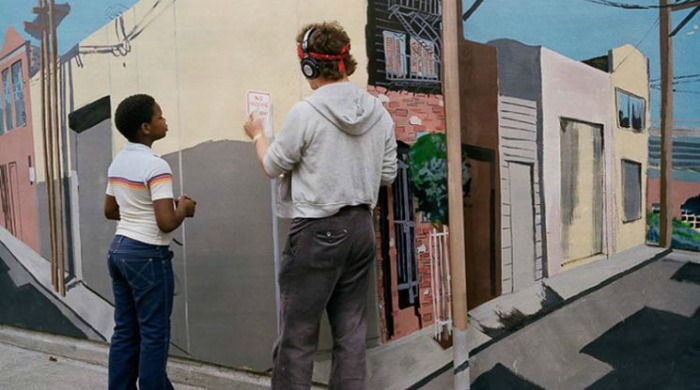 1970s San Francisco by Janet Delaney: A boy watching as a man paints a scene of a street on the wall on a sidewalk.