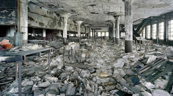Ruins of Detroit Yves Marchand Romain Meffre: A large space with pillars piled with rubbish.