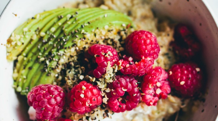 Breakfast Oatmeal Recipes: a bowl of protein boost oatmeal with avocados and raspberries.