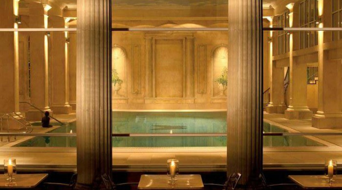 Five of the Best UK Spas: A beautiful indoor pool at Chewton Glen Hotel & Spa surrounded by Roman columns.