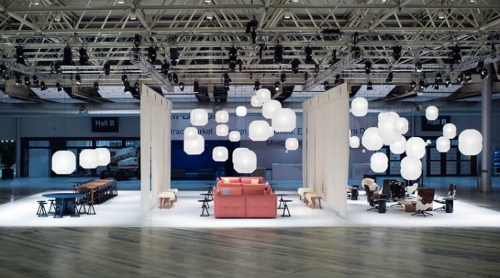 Barber & Osgerby's installation featuring pink sofas with many white Hotaru hanging lanterns at the Stockholm Furniture and Light Fair 2016.