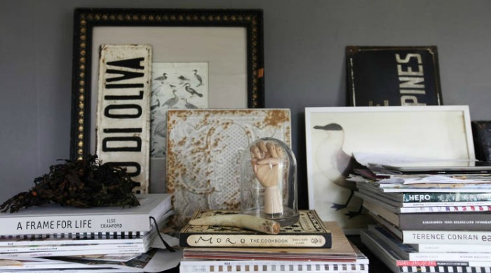 A collection of books and photos of birds with an old registration plate in a Swedish country house.