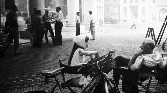 The Art of Behind the Scenes: Audrey Hepburn wearing a white headscarf and George Cukor pictured in conversation on the set of 'My Fair Lady'.
