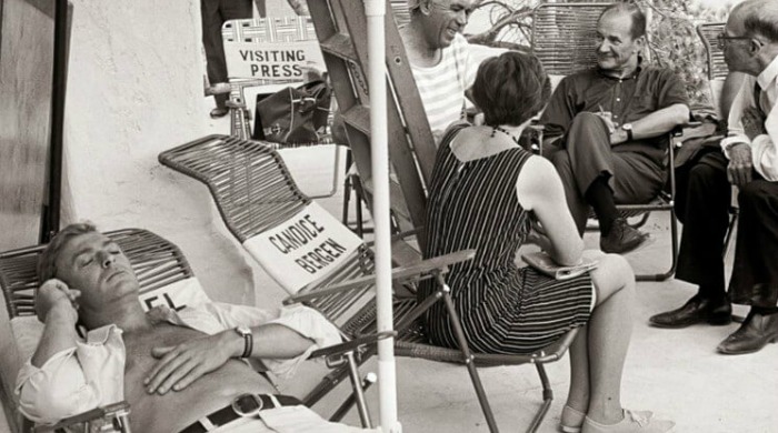 The Art of Behind the Scenes: Michael Caine resting on a deck chair with his eyes closed on the set of 'The Magus'.