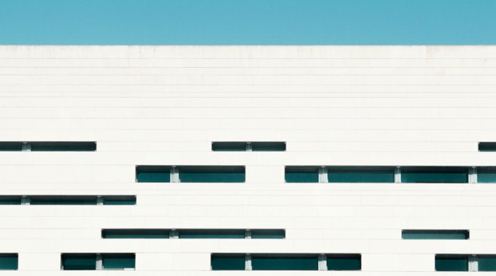 Part of the Universidade Nova de Lisboa in Lisbon, Portugal set against a bright blue sky by Maik Lipp.