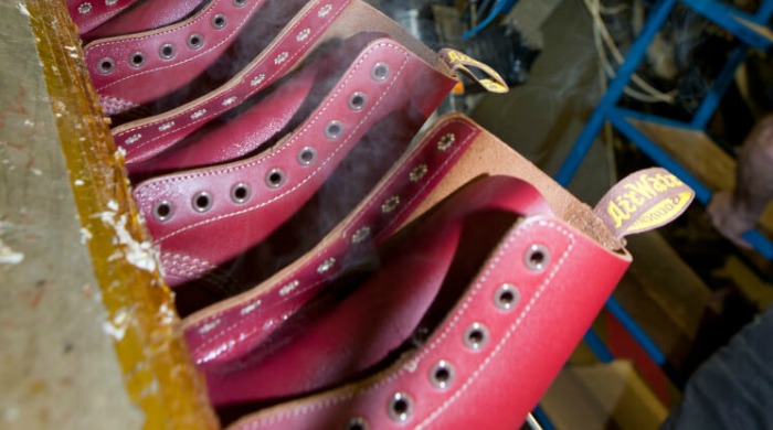 A row of red Dr. Martens boots being made.