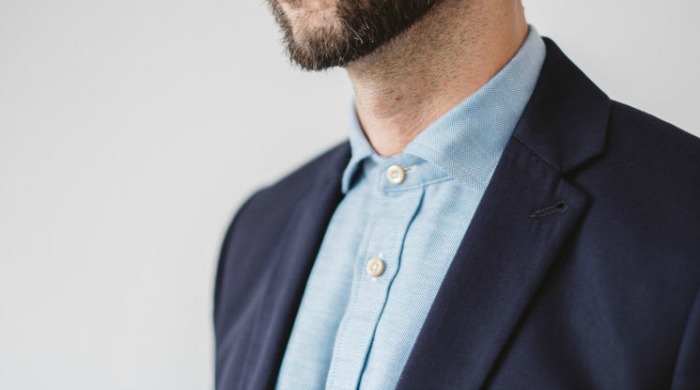 A man wearing a blue Tripl Stitched shirt.