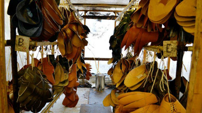 Leather uppers hung up at the Tricker's factory.