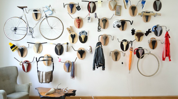 A wall of bike hanging racks designed to look like deer trophies by Andreas Scheiger.