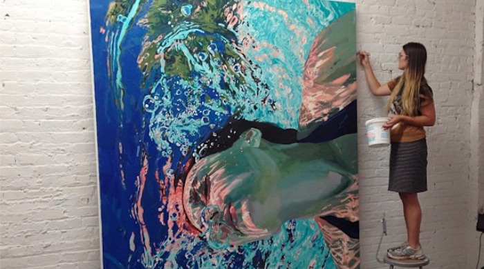 Samantha French painting an underwater painting of a woman.