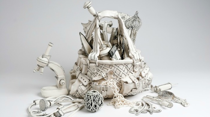 A ceramic basket of tools and equipment by Katharine Morling.