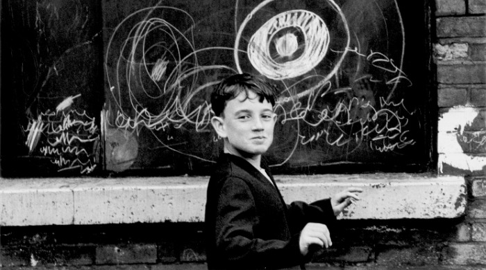 'Manchester' showing a boy on the street by Shirley Baker.