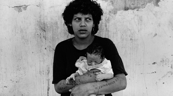A woman holding a baby from the series 'Imprisoned Women' by Adriana Lestido.