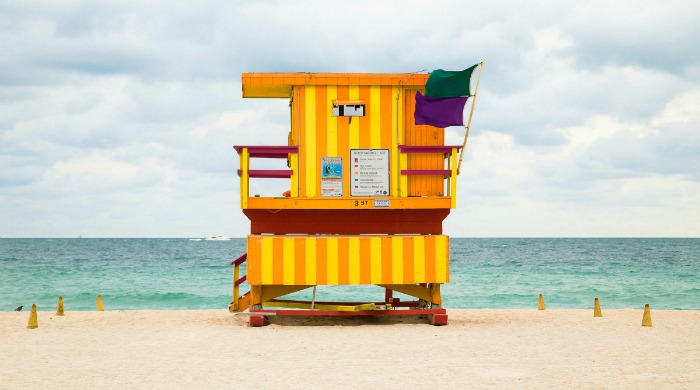A yellow Miami beach lookout tower photographed by Léo Caillard.