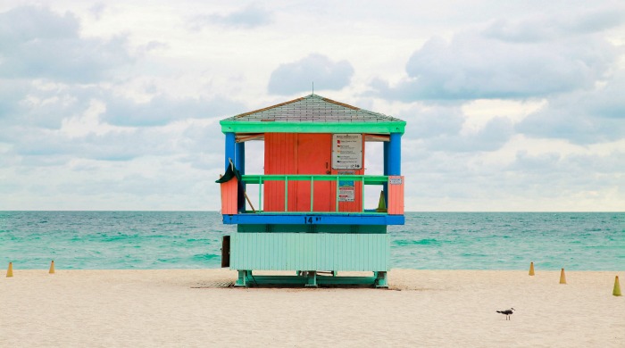 A red and green Miami beach lookout tower photographed by Léo Caillard.
