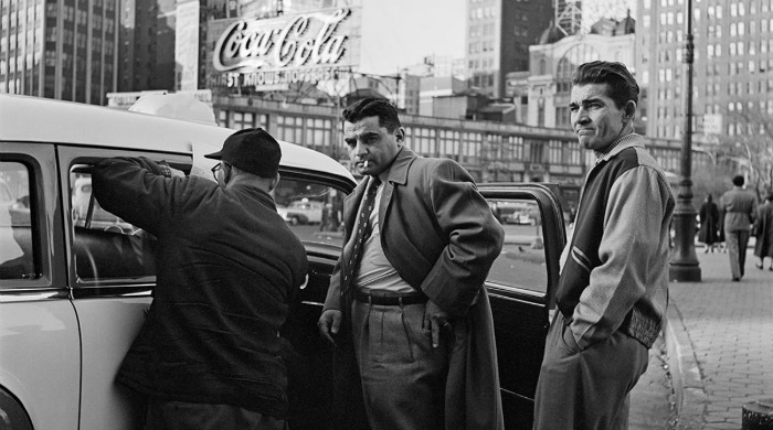 A street photograph of men getting into a cab by Vivian Maier.