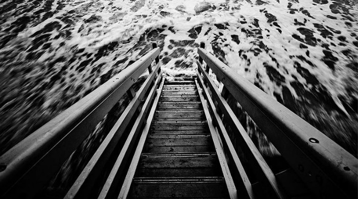 A staircase into the sea in black and white by Guy Cohen.