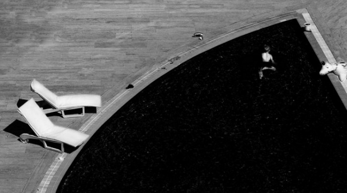 A figure in a black triangular pool by Kjetil Karlsen.