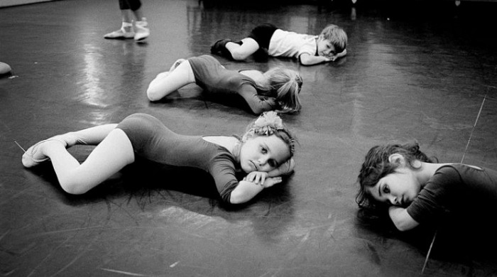 Young children lying on the floor in a ballet class by Viviana Peretti.