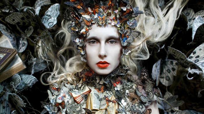A model decorated with books and butterflies from 'Wonderland' by Kirsty Mitchell.
