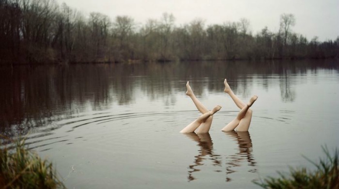 Mannequin legs posed in a lake by Jean-Baptiste Courtier.