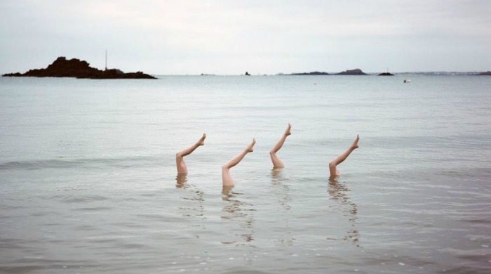 Mannequin legs posed in the sea by Jean-Baptiste Courtier.