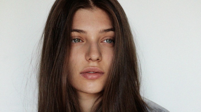 A portrait of a model with long brown hair by Sarah Louise Stedeford.