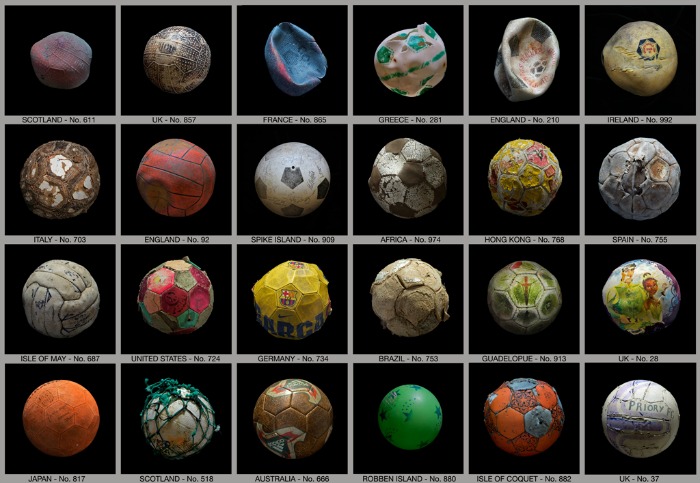 A grid of old footballs from a variety of different countries from 'Penalty' by Mandy Barker.