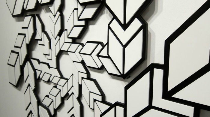 A black and white geometric pattern by Aakash Nihalani.