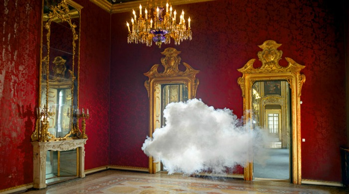 A cloud floating in a grand red room by Berndnaut Smilde.