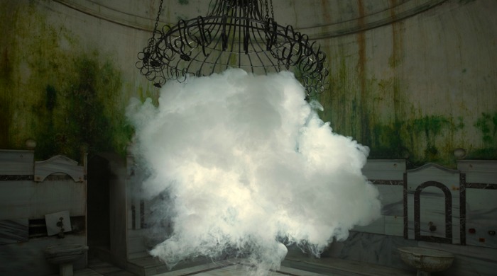 A cloud floating under a broken chandelier in a derelict room by Berndnaut Smilde.