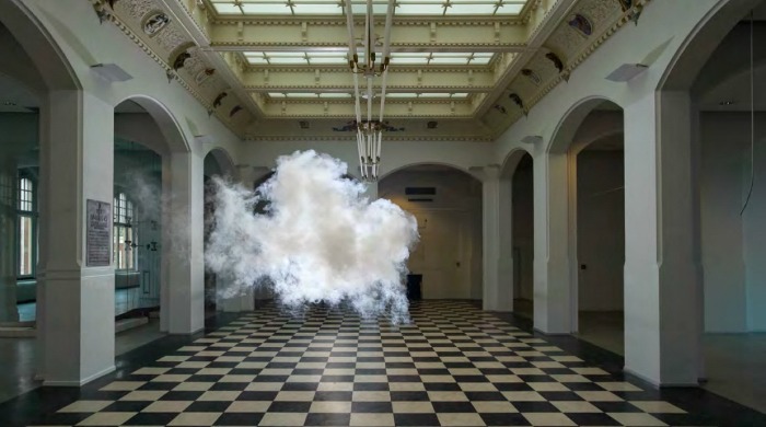 A cloud floating above a black and white tiled floor by Berndnaut Smilde.