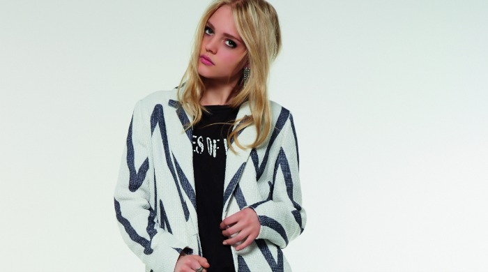 A model wearing a blue and white striped Gestuz blazer.